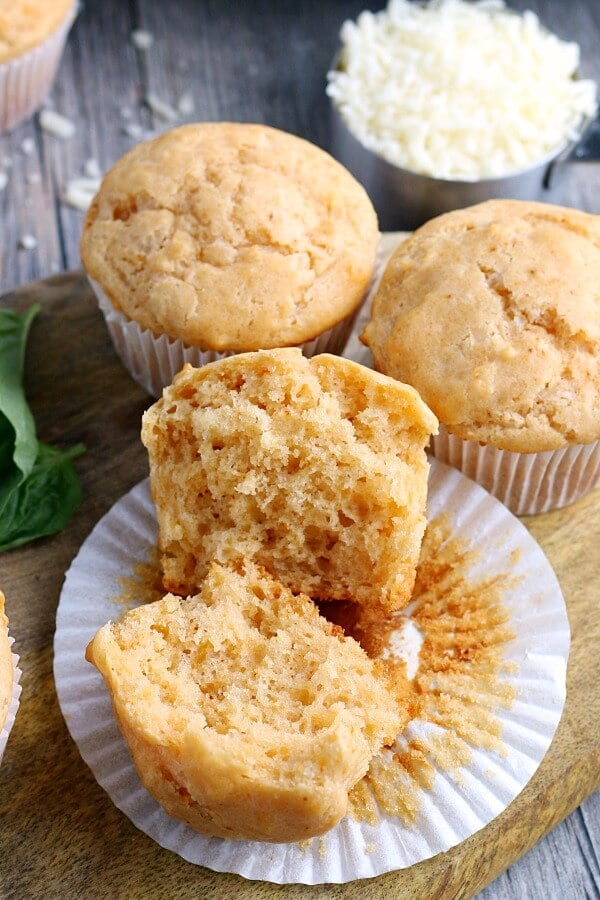 A close up view of one of the savory parmesan muffins cracked open to show the delicious center. 