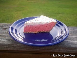 Sweet Tart Cheesecake Pie on blue plate side view.