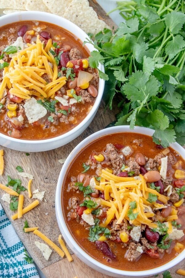 two bowls of Taco Soup with tortilla chips and cilantro