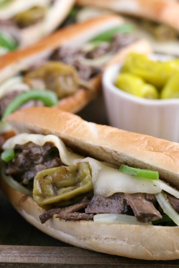 finished Crockpot Italian beef on sandwiches with cheese and peppers. 