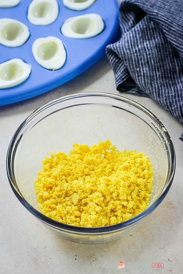 Classic Deviled Eggs yolks mashed in bowl