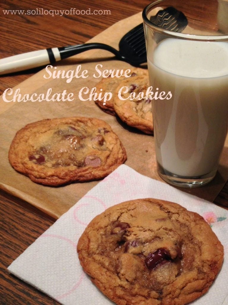 Single Serve Chocolate Chip Cookies on cutting board with a glass of milk and a spatula. 