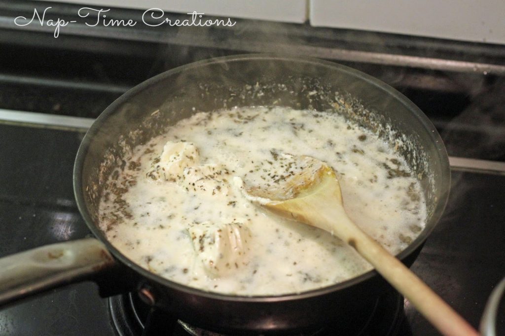 Better for you Alfredo Sauce cooking in a pan on the stove. 
