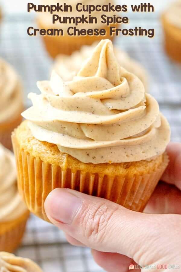 Pumpkin Cupcake with Pumpkin Spice Cream Cheese Frosting being held in hand.