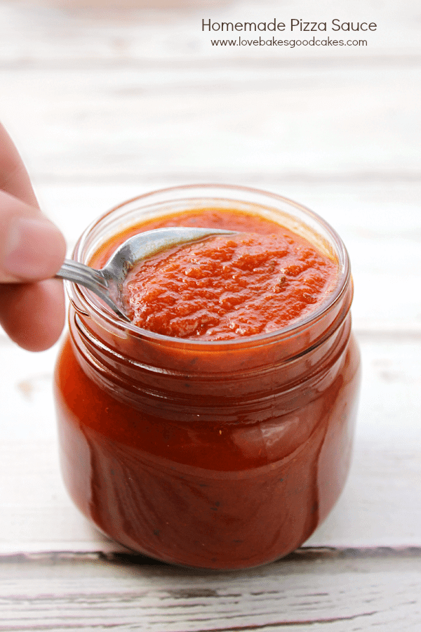 Homemade Pizza Sauce in a jar with a spoon.