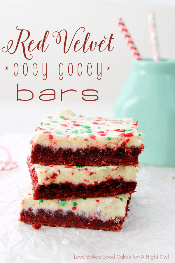 Red Velvet Ooey Gooey Bars stacked up with a glass of milk.
