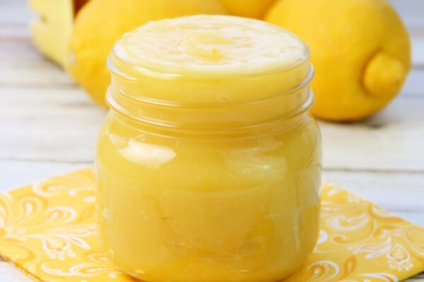 lemon curd in jar on yellow napkin