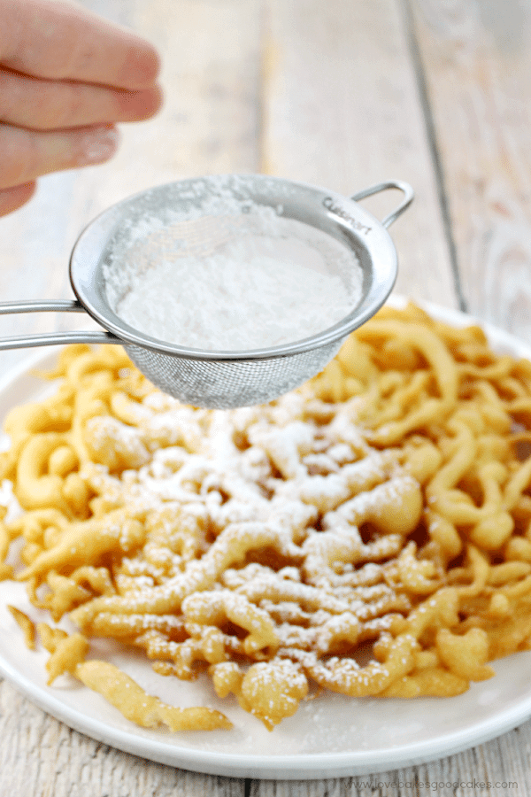 County Fair Funnel Cake with powdered sugar being sprinkled on top.