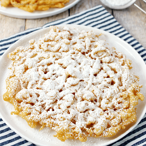 County Fair Funnel Cake close up on a plate with powdered sugar.