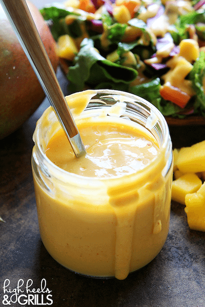 Creamy Mango Chipotle Dressing in a glass jar with a spoon.
