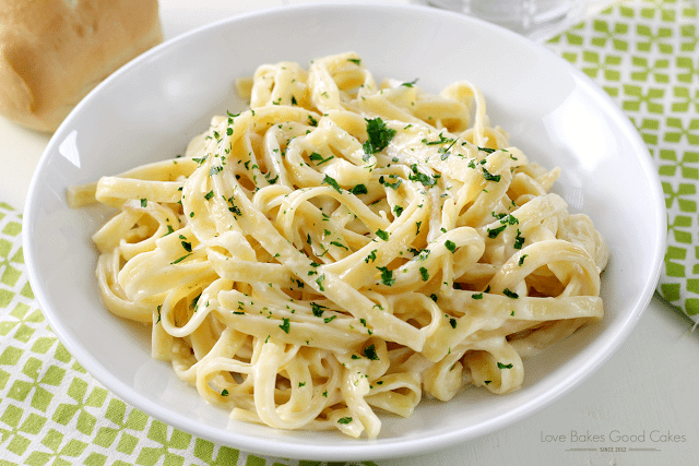 Pasta and Alfredo Sauce in a white bowl.
