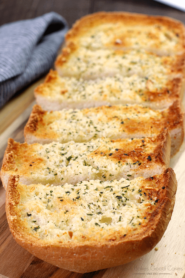BEST Garlic Bread sliced on a cutting board close up.