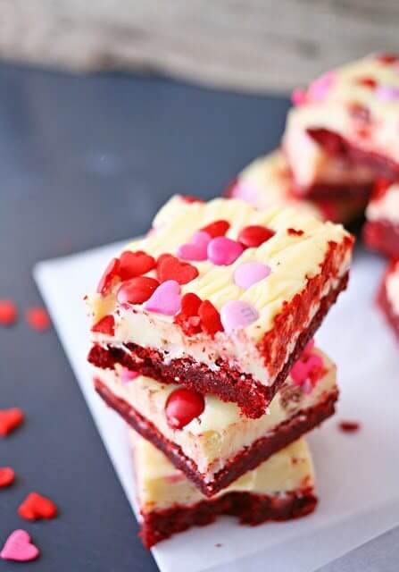 Valentine Red Velvet Brownies stacked on a piece of parchment paper. valentine's day food ideas