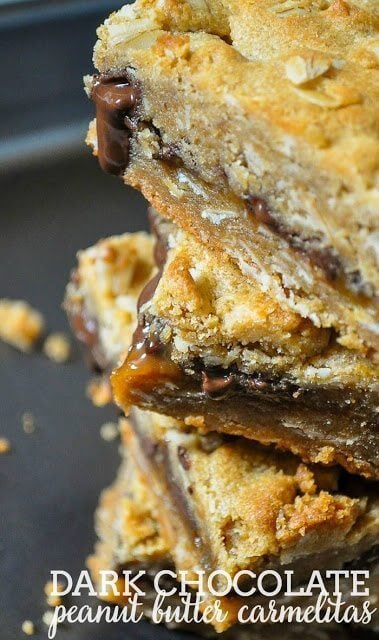Dark Chocolate Peanut Butter Carmelitas stacked up on each other close up.