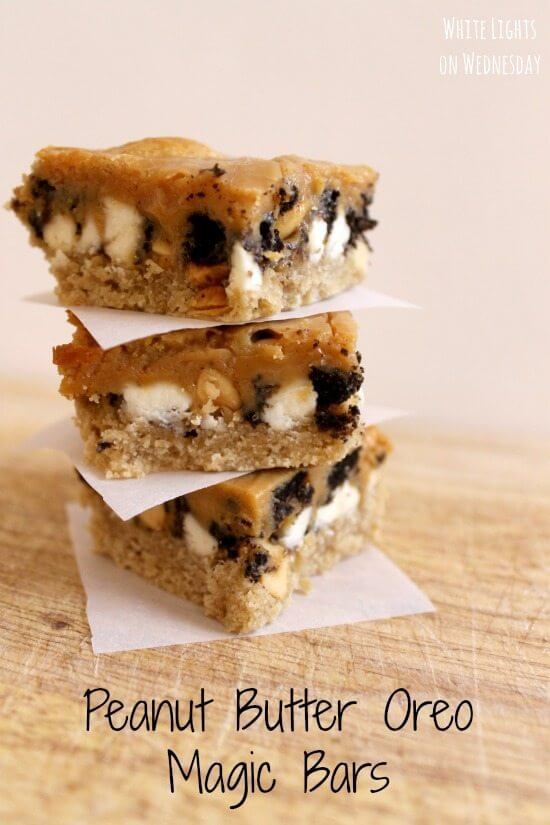 Peanut Butter Oreo Magic Bars stacked up on parchment paper.