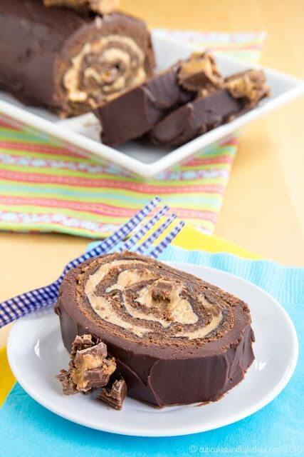 Peanut Butter Cup Flourless Chocolate Cake Roll on a plate.