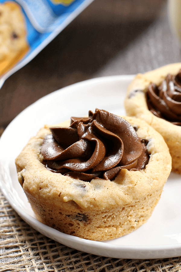 Chocolate Chip Cookie Cups with Chocolate Buttercream Frosting on a plate close up.