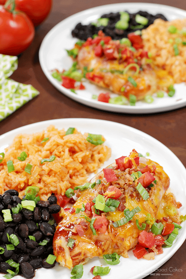 Baked Monterey Chicken on white plates with Mexican rice.