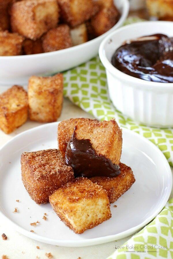 Churros Bites with Chocolate Dipping Sauce on a white plate with a bowl of dipping sauce.
