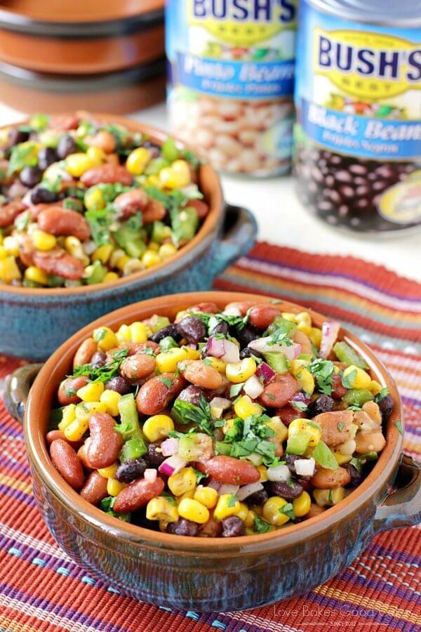 Mexican Bean Salad in two bowls with two cans of Bush's Beans.