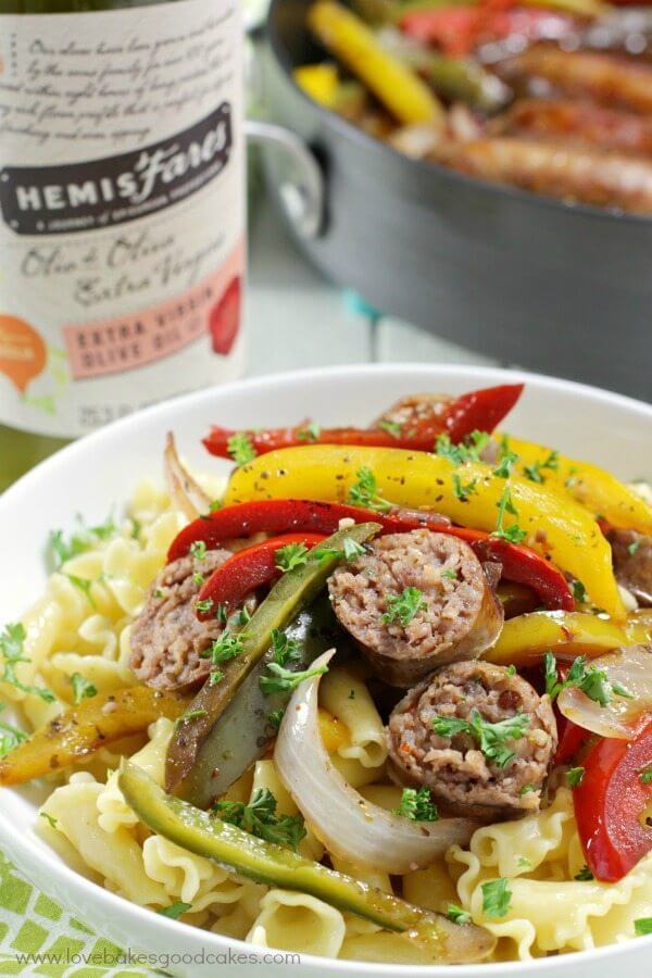 Rustic Italian Sausage with Peppers and Onions in a white bowl.