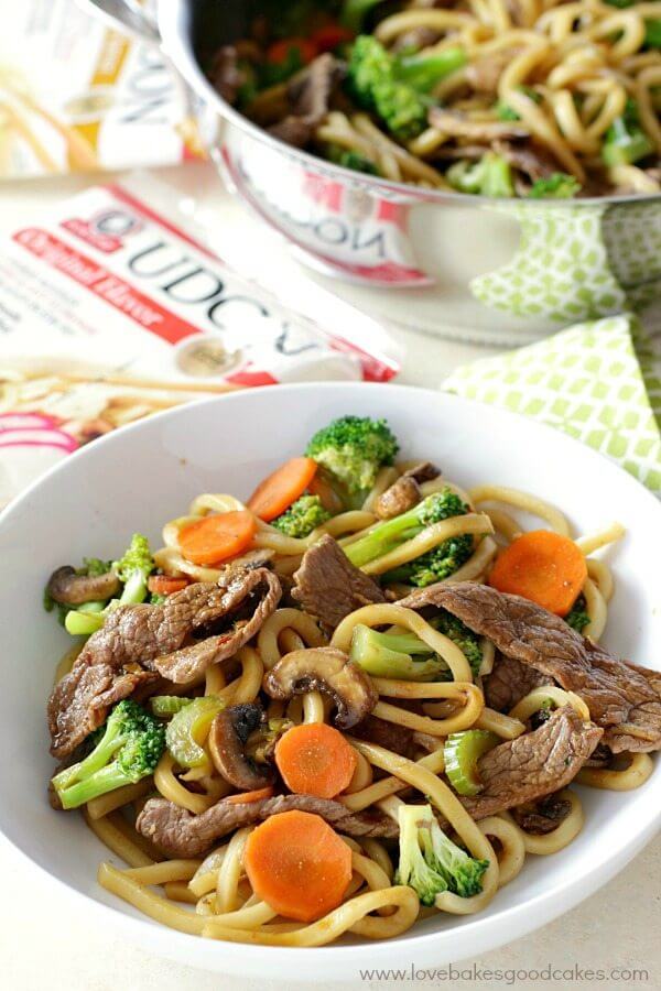 Hoisin Beef Noodle Stir Fry in a white bowl and in a skillet.