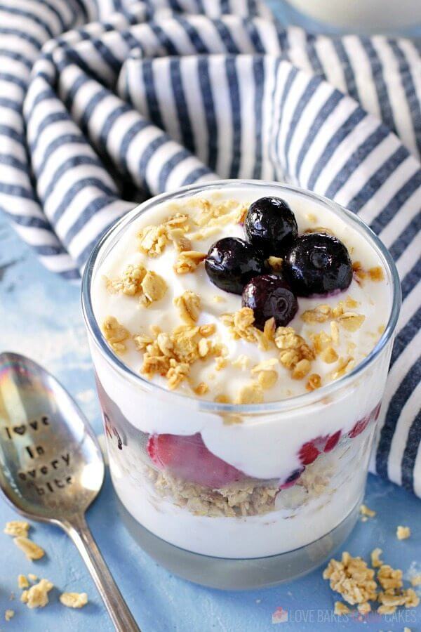 Fruit and Yogurt Breakfast Parfait in a glass with a spoon.
