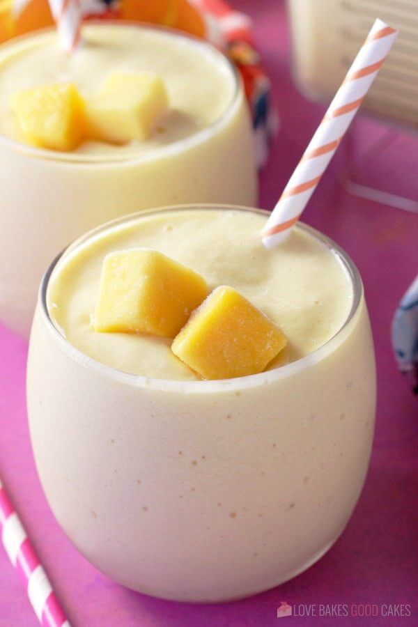 Sunshine Smoothie with Banana and Mango in two glasses with straws.