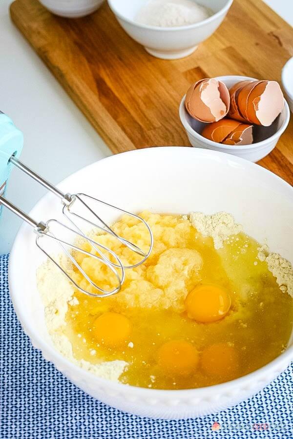 Cake mix, eggs, and pineapple in bowl