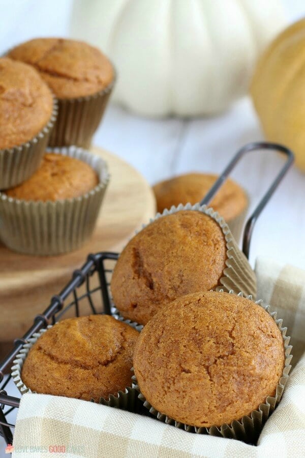 Pumpkin Muffins in a basket and on a cutting board.