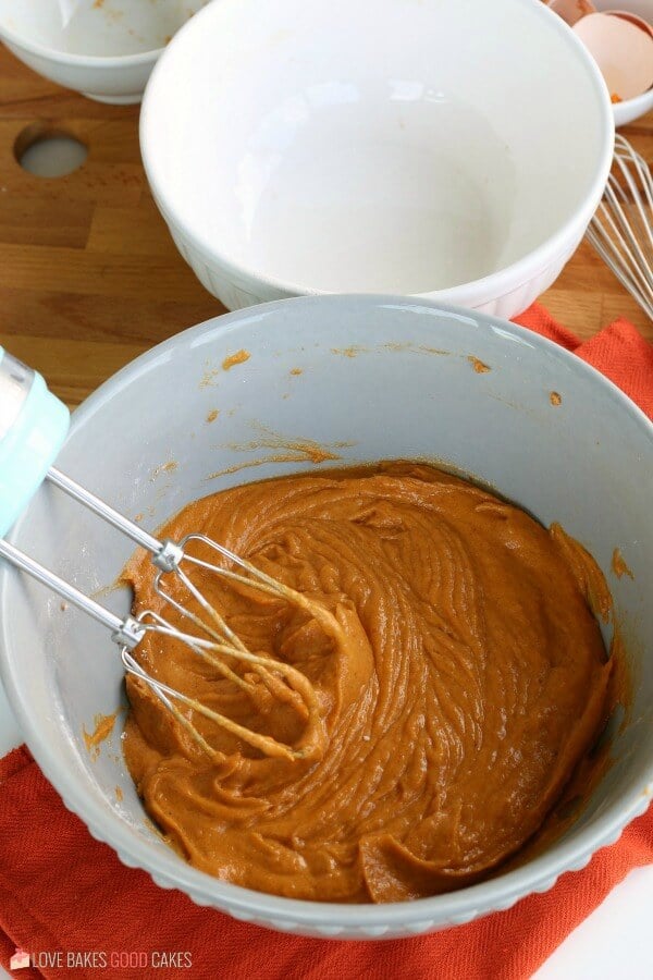 Pumpkin muffins batter mixed together in a mixing bowl.