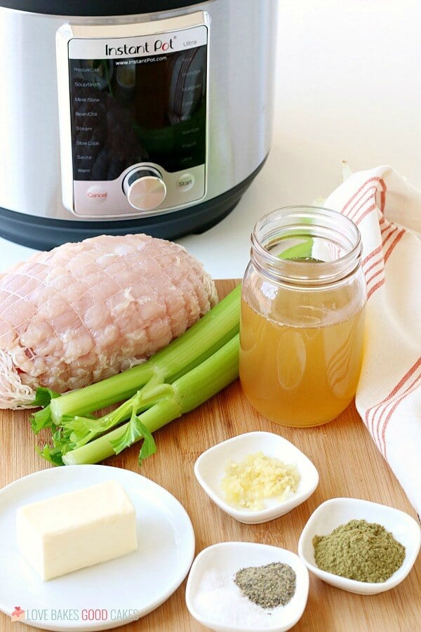 Image shows frozen turkey breast, stock, and seasonings needed to make this Instant Pot turkey breast recipe. 