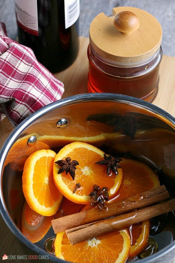 Next we add the cinnamon sticks and honey to the mulled wine recipe. 