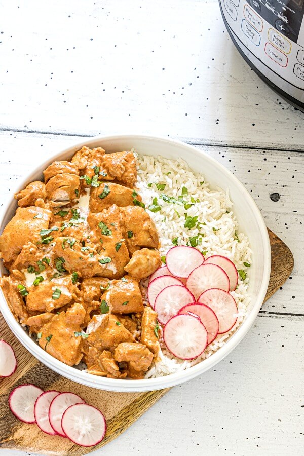 instant pot butter chicken with rice in bowl - instant pot in corner