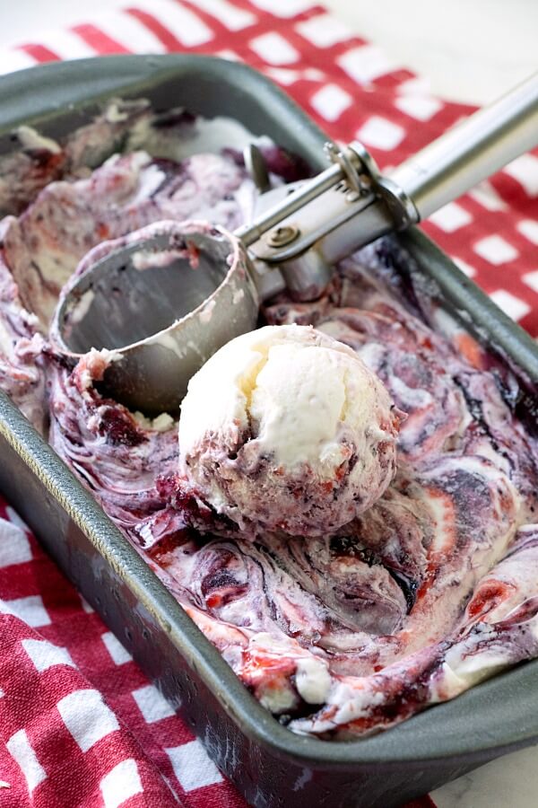 scoop of ice cream on top of ice cream in metal baking dish