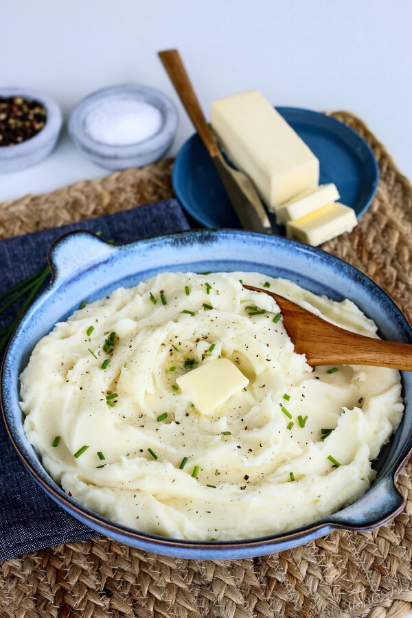 bowl of mashed potatoes with serving spoon