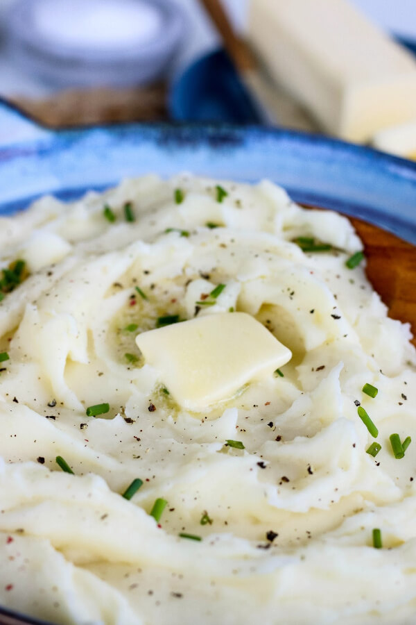 pat of butter and chives on top of mashed potatoes
