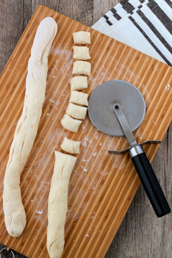 pretzel bite dough being cut to form bites