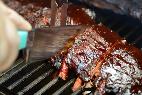 smoked ribs being cut