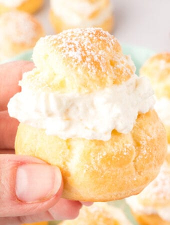 closeup of a hand holding a cream puff