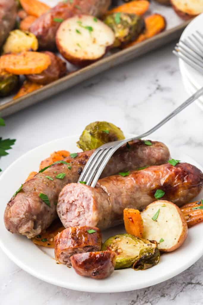 serving of baked sausage and veggies on plate