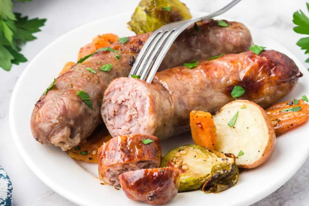 serving of sheet pan sausage and veggies on plate