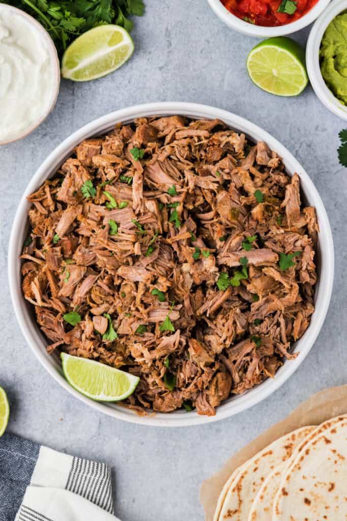 looking down into a bowl filled with instant pot carnitas