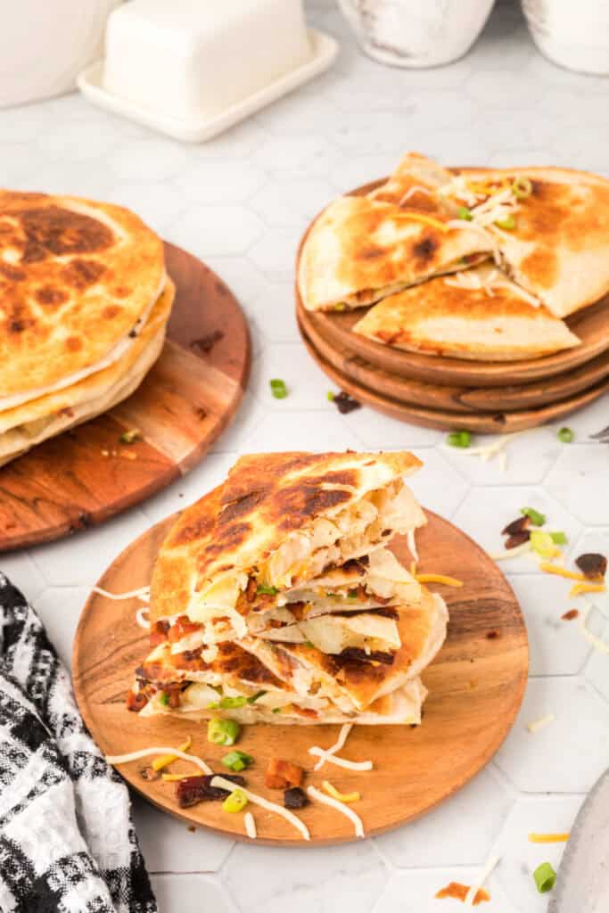 loaded baked potato quesadilla on wooden cutting board