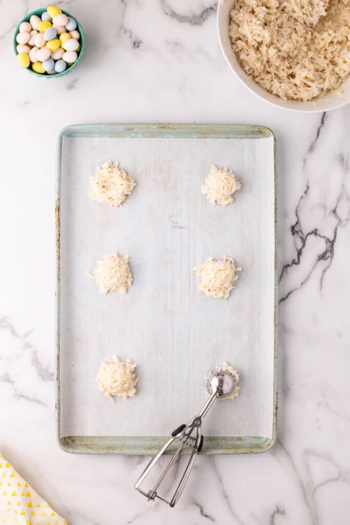 cookies being scooped onto sheet pan