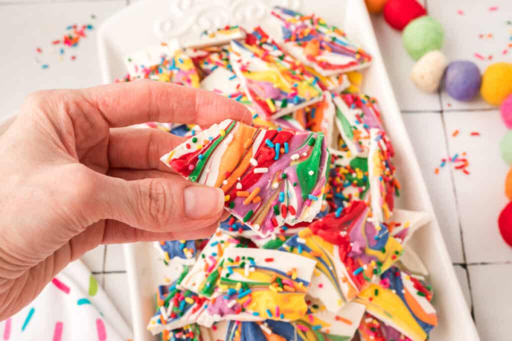 closeup of hand holding a piece of candy bark