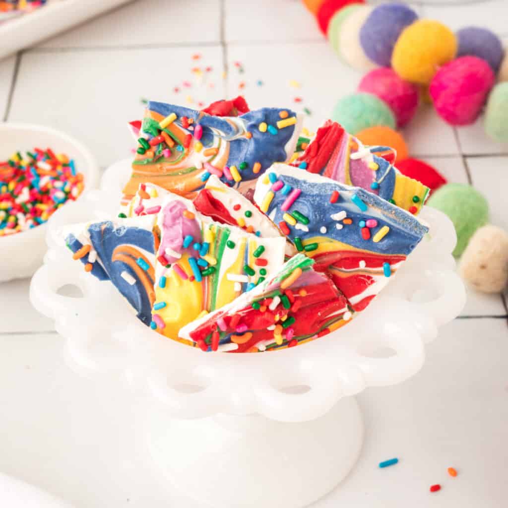 rainbow candy bark in a small white candy dish