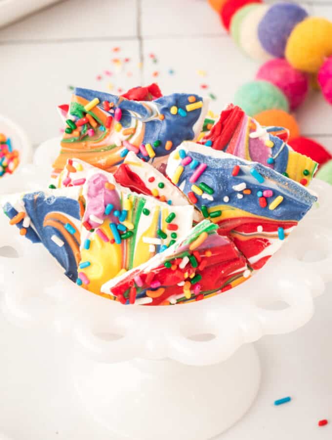 rainbow candy bark in a small white candy dish