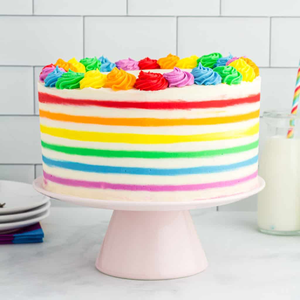 rainbow striped funfetti cake on cake stand